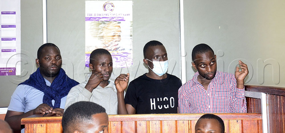 From Left: Police officers Kulutu, Waiswa, Emorut, and Waiswa Siraje in the dock at City Hall Magistrates' Court, where they were charged with conspiracy to commit a felony. They were remanded to Luzira until September 7, 2026. (Photo by Margret Zalwango)