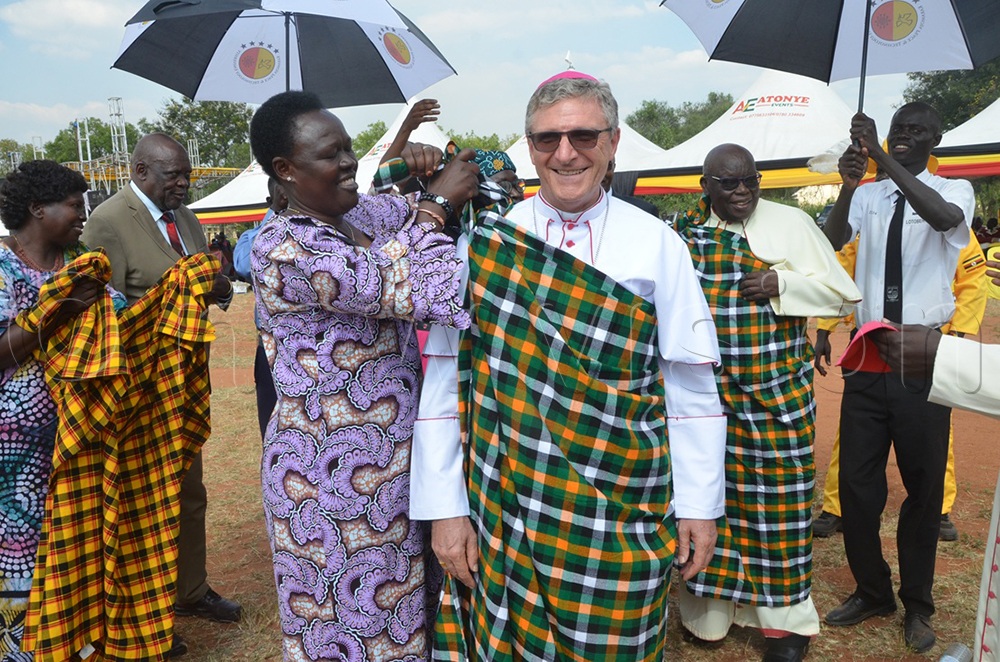 The Bishop of Moroto Diocese, Damiano Guzzetti, being dressed in the traditional Karimojong sheet at the event during the unveiling of the university project in Kotido district. (Credit: Olandason Wanyama)