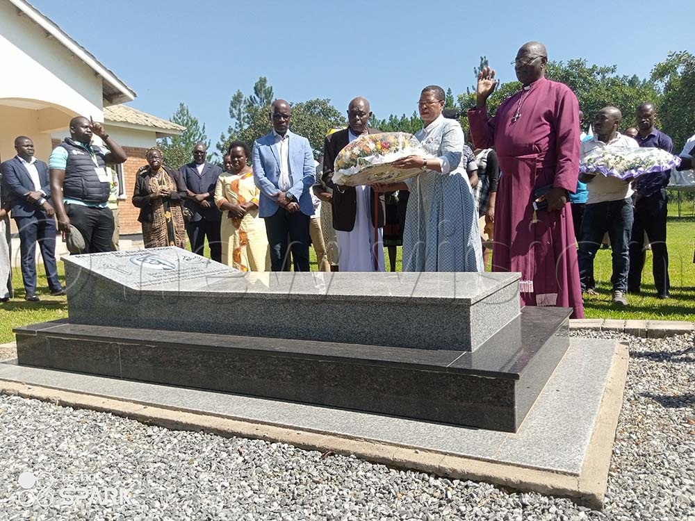 Speaker Anita Among lays a wreath on Jacob Oulanyah’s grave flanked by Obua (blue blazer) in August last year at Ayomlony village, Lalogi sub-county, Omoro district. File Photo