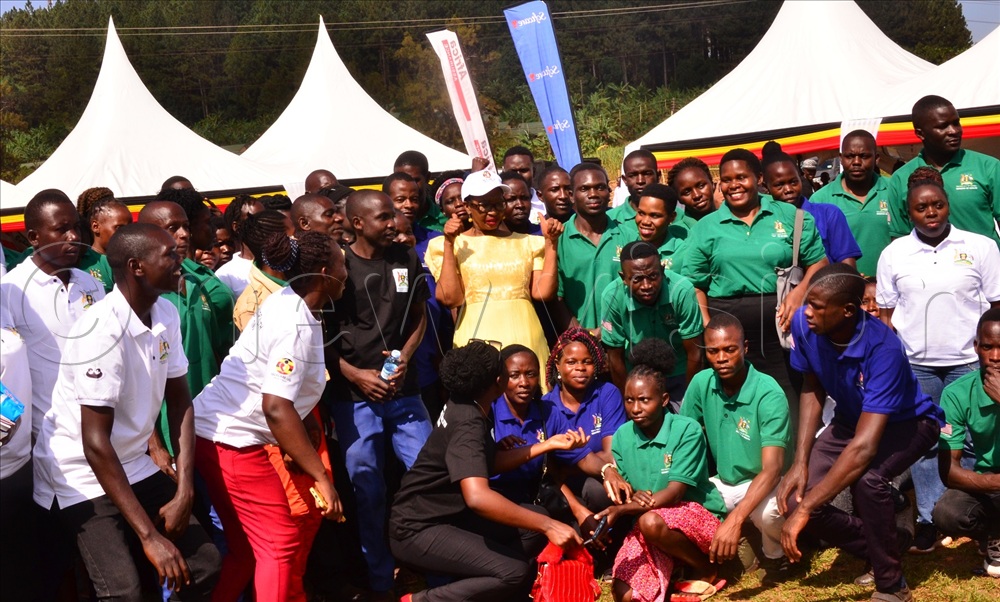 State Minister for Health in charge of general duties, Hanifa Bangirana Kawooya (centre in yellow dress), in a group photo with the community health workers. 