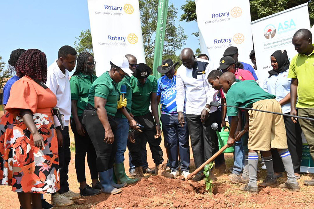 Environmental Conservation: Rotary leaders together with Jjanyi Primary School pupils plant a tree. (Courtesy photo)