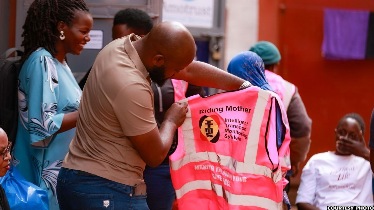 Steven Turyarugayo of ITMS displaying one of the donated reflector jackets