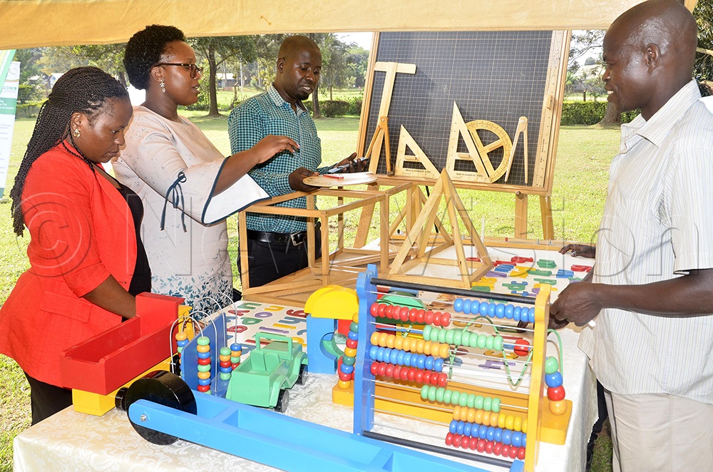 A teacher inspects some of the materials used in early childhood education during an exhibition at the pre-conference for the forthcoming 2nd International Conference at the National Curriculum Development Centre (NCDC) in Kampala on August 18, 2026. (Photo by Wilfred Sanya)