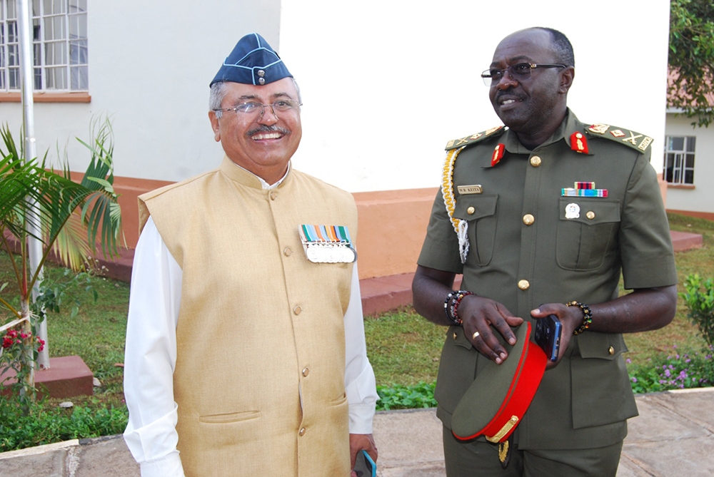 National Forensic Science University-Uganda campus director Air Commodore, Kedar Thaakar, sharing a light moment with Wyclif Keita, the joint staff training and doctrine. (Courtesy Photo)