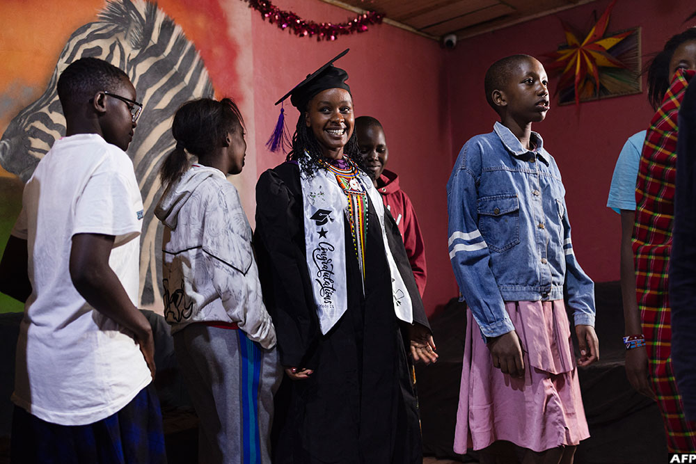 Girls at the House of Hope celebrate the graduation of 24-year-old Cecilia Nairuko, at the centre that shelters and educates girls rescued from FGM and child marriage, in Narok County. (AFP)