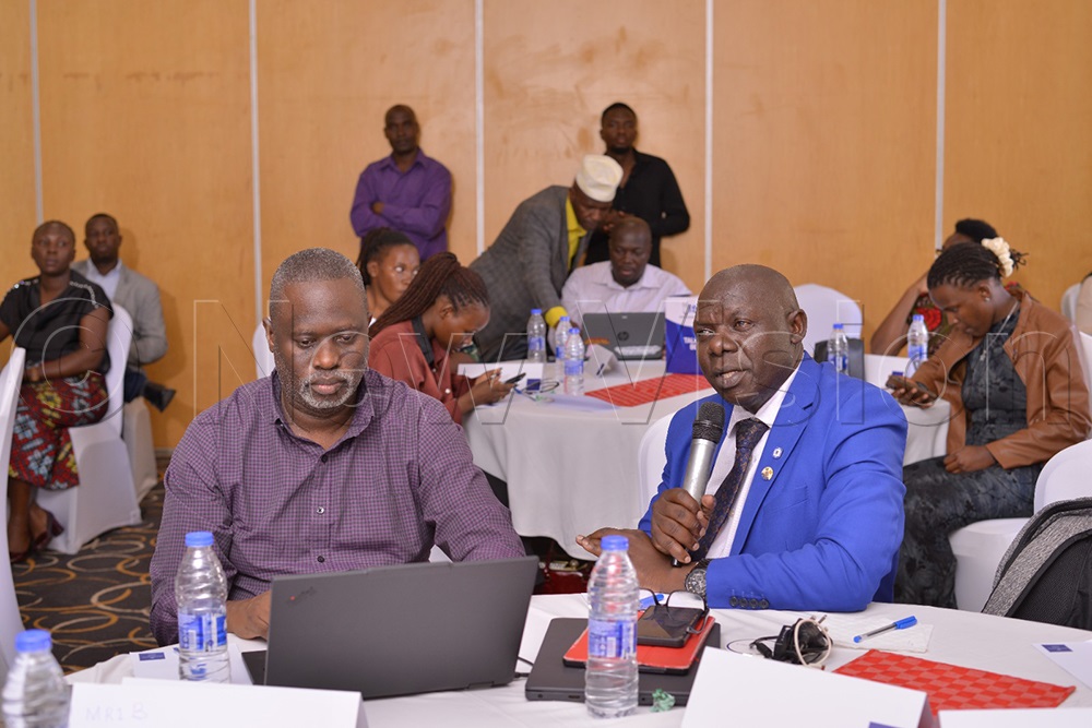 Kizito Musasizi, the Buikwe District Education Officer (right), speaking during the launch at Protea Hotel Kampala. (Credit: Rhyman Agaba)