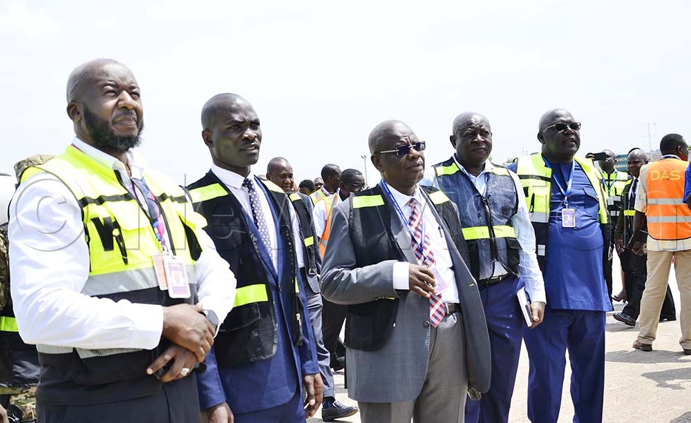 Fred Byamukama, Works and transport minister, Fred Bamwesigye, UCAA Director General together with other officials look at the water cannon salute of the jet at Entebbe International Airport on 1st October 2026. (Credit: Juliet Kasirye)