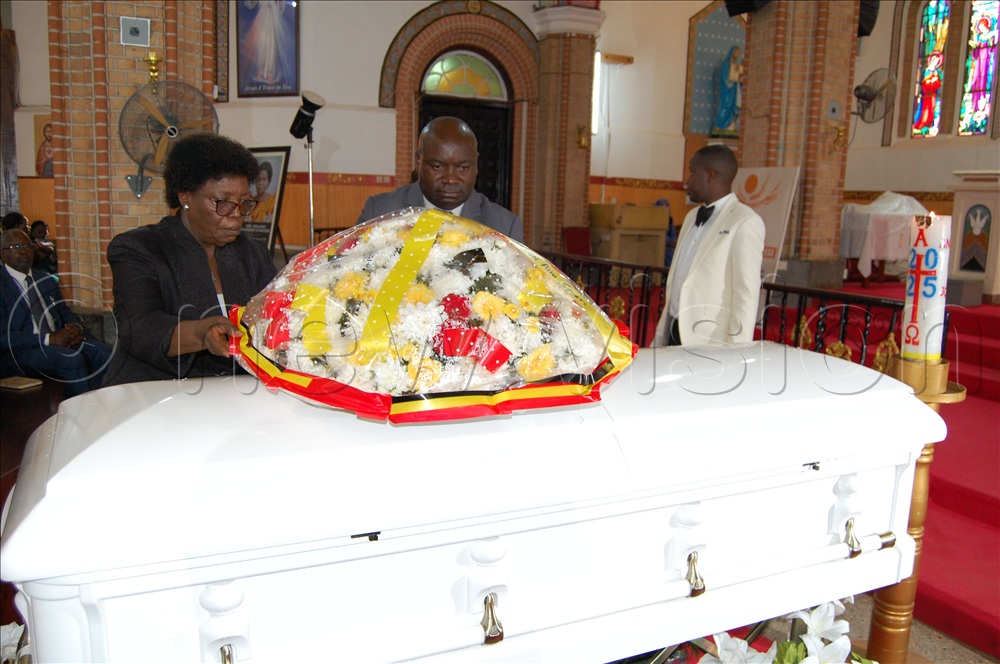 Ministry of education representatives, Prof. Mary Okwakol and Cleophas Mugenyi laying a wreath on the casket bearing the remains of Hon. Geraldine Namirembe Bitamazire during the requiem mass at Lubaga Cathedral on Tuesday, January 20, 2026.