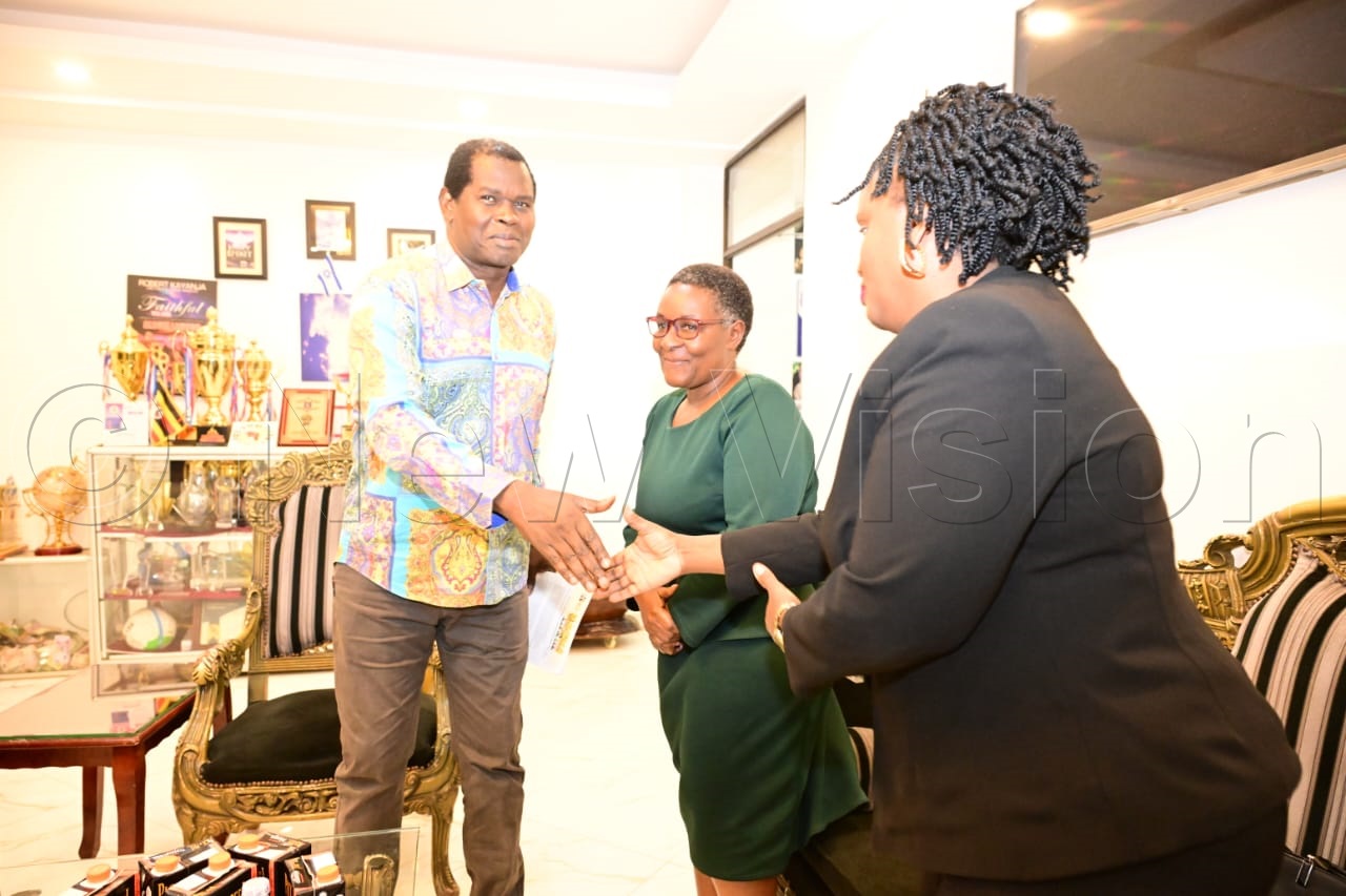 Pastor Kayanja greets Vision Group head of sales, Hope Nuwagaba.