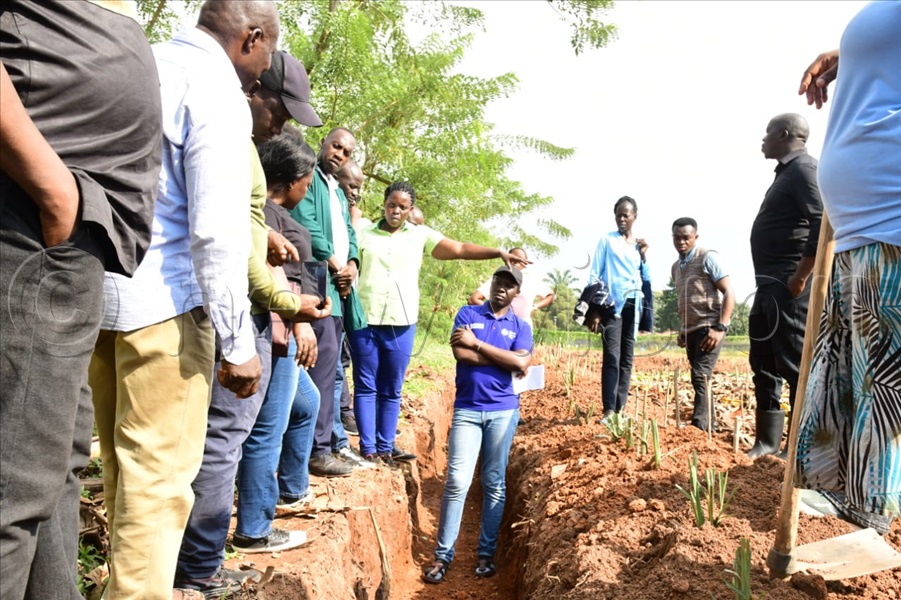 Dr. Eseri Nankya, a trainer from NARO explaining about the infiltrating pits at Kawanda agricultural research institute.
