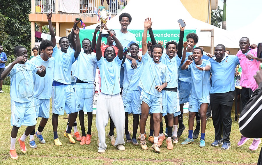 Vikas International School football team celebrate with their trophy after the Independence tournament. Photo by Michael Nsubuga