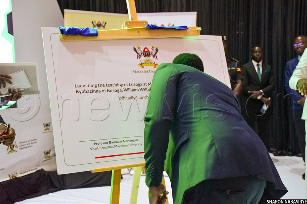 His Royal Highness William Wilberforce Gabula Nadiope IV, the Kyabazinga of Busoga signing on a dummy during the launch of Lusoga teaching at Makerere University. (Photo by Sharon Nabasirye)