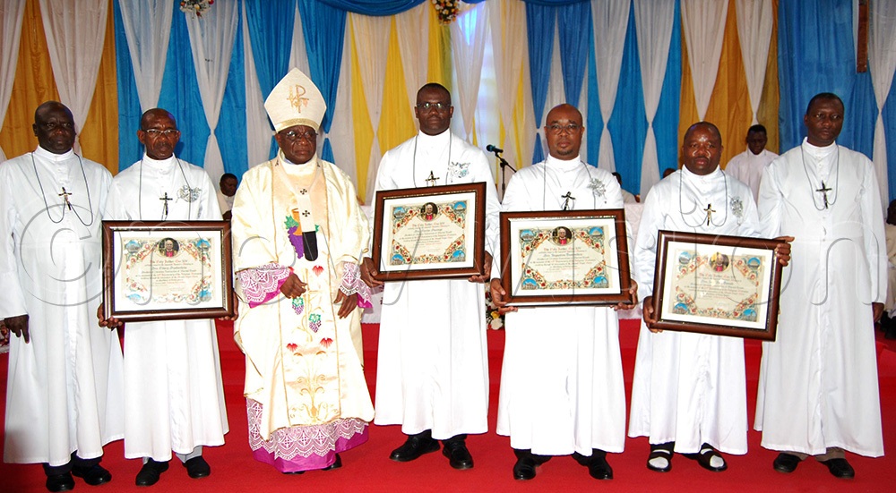 The Brothers of Christian Instruction who celebrated 25 years in religious life, namely Bro. Hilary Byabasheija (second-left), Bro. Marius Murongo (fourth-left), Bro. Augustine Tumwebaze (fifth-left), and Bro. John Paul Tamale (second-right), share a photo-moment with Archbishop Paul Ssemogerere (wearing a mitre), Bro. Casio Aizire (left) and Bro. Anthony Kanuhanda. (Photo by Mathias Mazinga)
