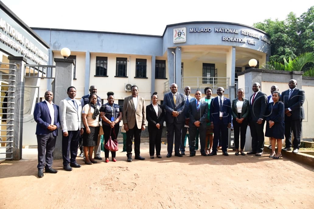 Health Minister Dr Chris Baryomunsi in a group photo with health officials at the Mulago Isolation Unit. (Credit: Mpalanyi Ssentongo)