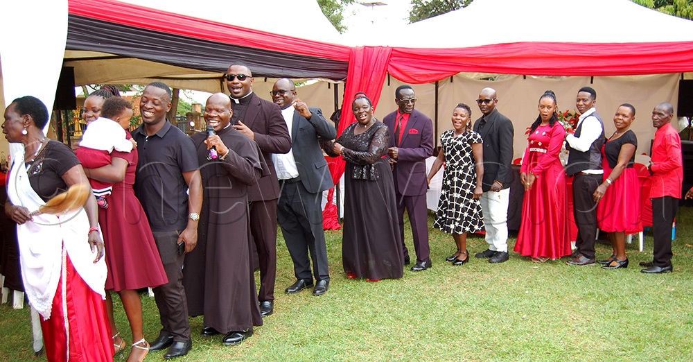 The Holy Cross Fathers, 4rd-5th-left: Fr. John Baptist Nsubuga, Fr. John Baptist Ssemaganda and Fr. Dennis Lule dancing with couples in celebration of St. Valentine' Day at Nsambya Catholic Parish Gardens on Saturday, February 14. (Photo by Mathias Mazinga)