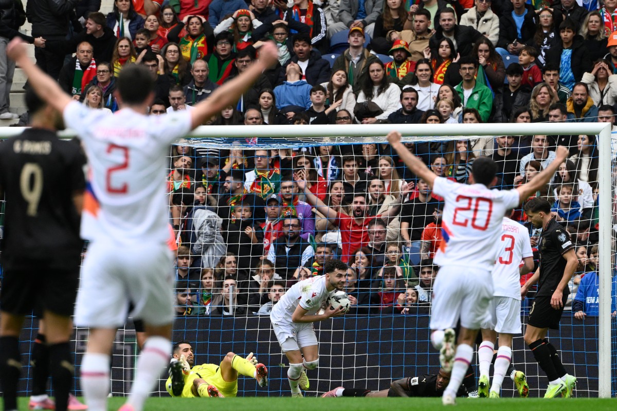 Armenia's midfielder #08 Eduard Spertsyan celebrates scoring an equalizing goal during the 2026 World Cup qualifiers Europe zone group F football match between Portugal and Armenia, at Dragao stadium in Porto on November 16, 2025.