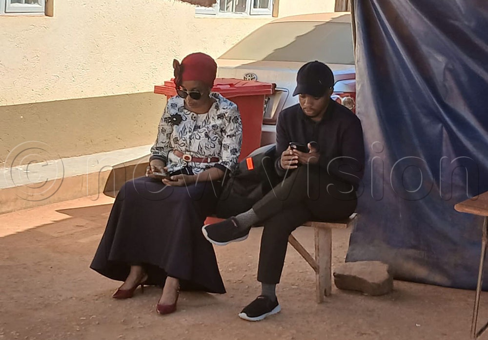 Lukwago's wife and son at Kira Road Police. (Credit: Ponsiano Nsimbi)