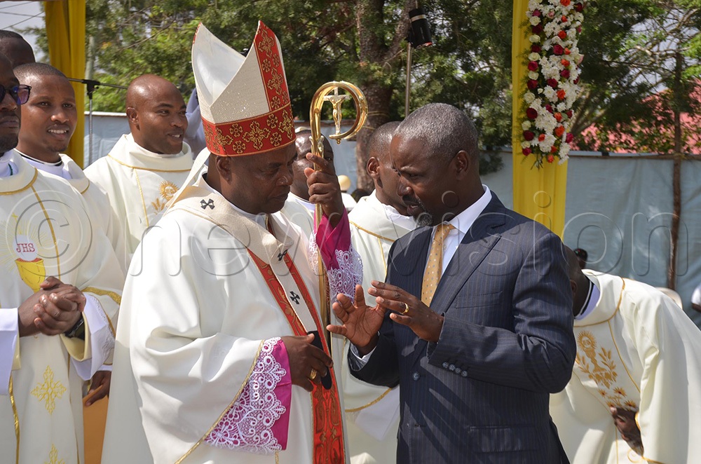 The Archbishop of Mbarara Archdiocese, His Grace Lambert Bainomugisha, interacts with the Deputy Speaker of Parliament, Thomas Tayebwa, as the newly ordained priests and deacons look on. This was shortly after the ordination ceremony on Saturday at Nyamitanga Cathedral in Mbarara City. (Photo by Abdulkarim Ssengendo)