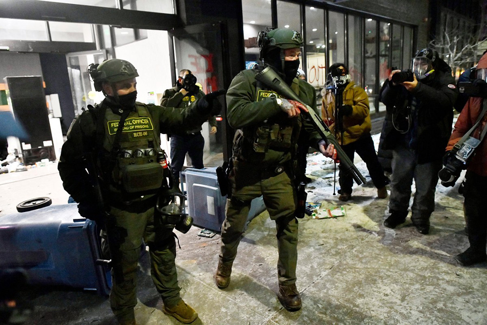 Two women hug at a makeshift memorial in the area where Alex Pretti was shot dead by federal immigration agents in Minneapolis, Minnesota, on January 26, 2026. (Photo by ROBERTO SCHMIDT / AFP)
