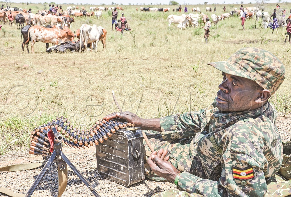 A UPDF officer on guard during a search for stolen cattle in Moroto. Residents says some innocent people have been unlawfully detained following the disarmament exercise.