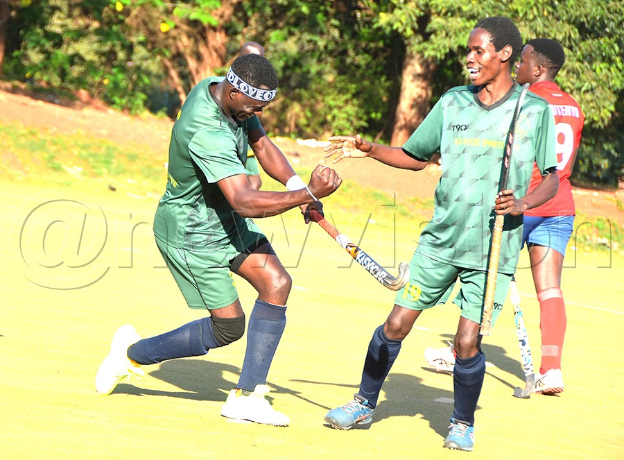 Wananchi players Jackson Musinguzi (left) and Emmanuel Baguma (right) celebrate a goal during their 5-0 victory over Kampala HC in the second leg of the Uganda Cup quarter-final at Lugogo. Photo: Silvano Kibuuka