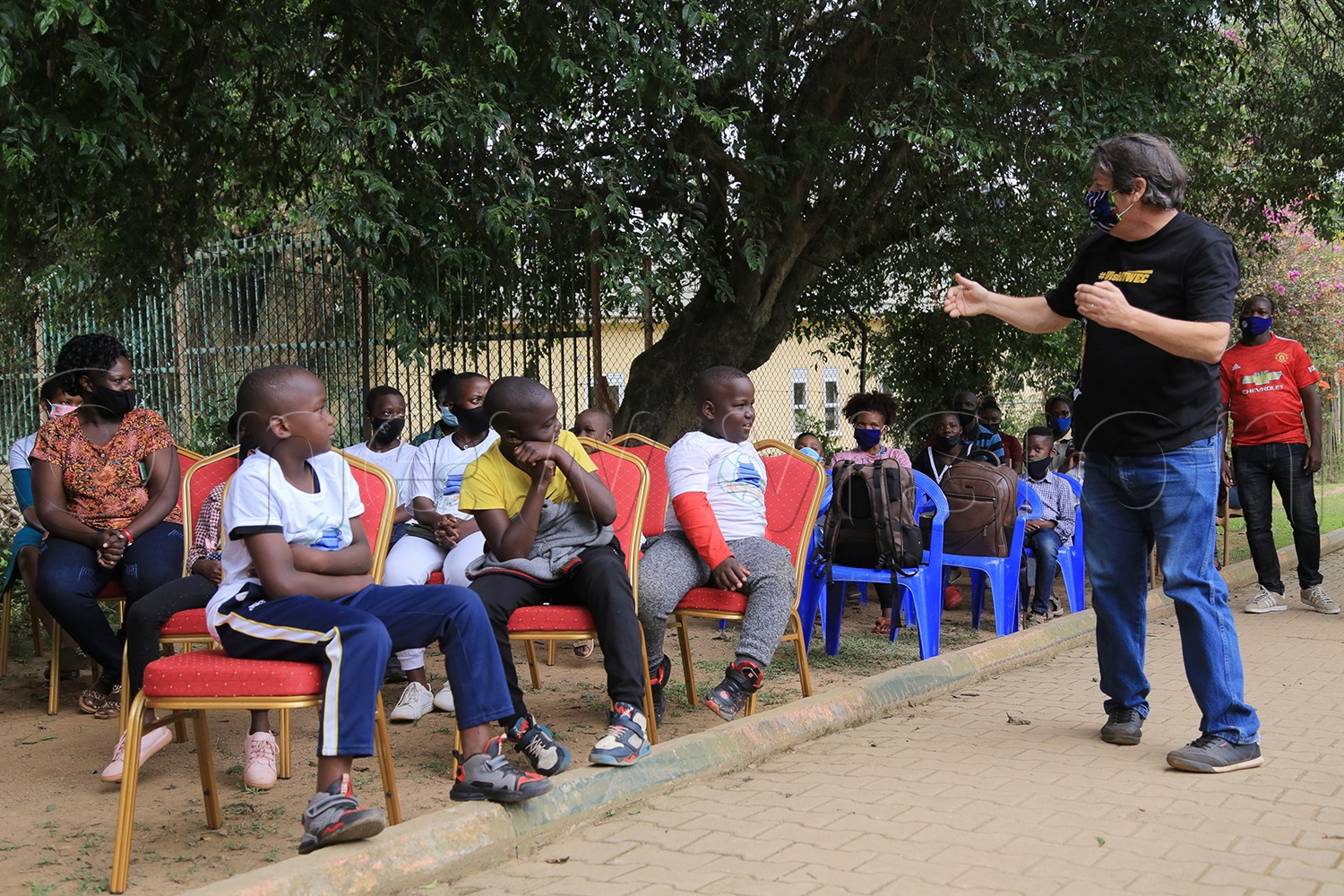 Cotham engages children after the library launch. (Credit: Ritah Mukasa)