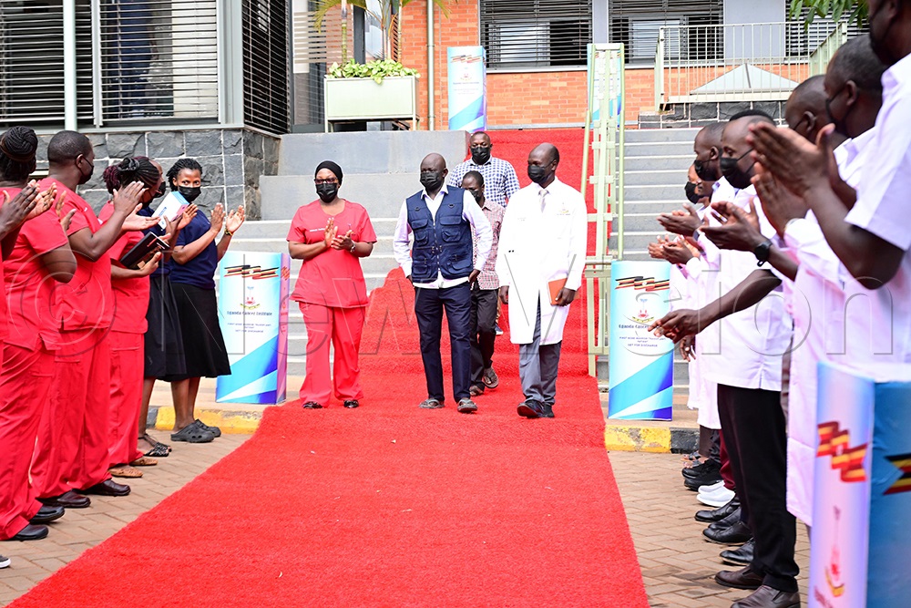 The first bone marrow transplant patient Sande Stephen in (center) accompanied by Dr Clement Okello and Sr Hanifah Nabbanja receives a warm discharge from hospital after a successful bone marrow transplant. This was at Uganda Cancer Institute in Mulago. (Photo by Maria Wamala)
