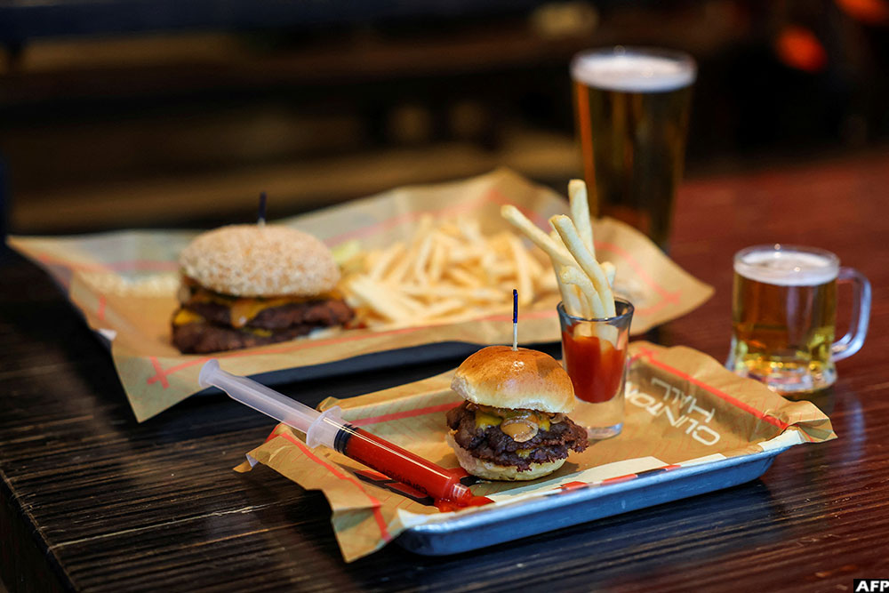  A mini burger, mini fries and mini beer, Clinton Hall&rsquo;s "Teeny Weeny Mini Meal&rdquo;, is pictured next to a regular-sized combo in New York City.