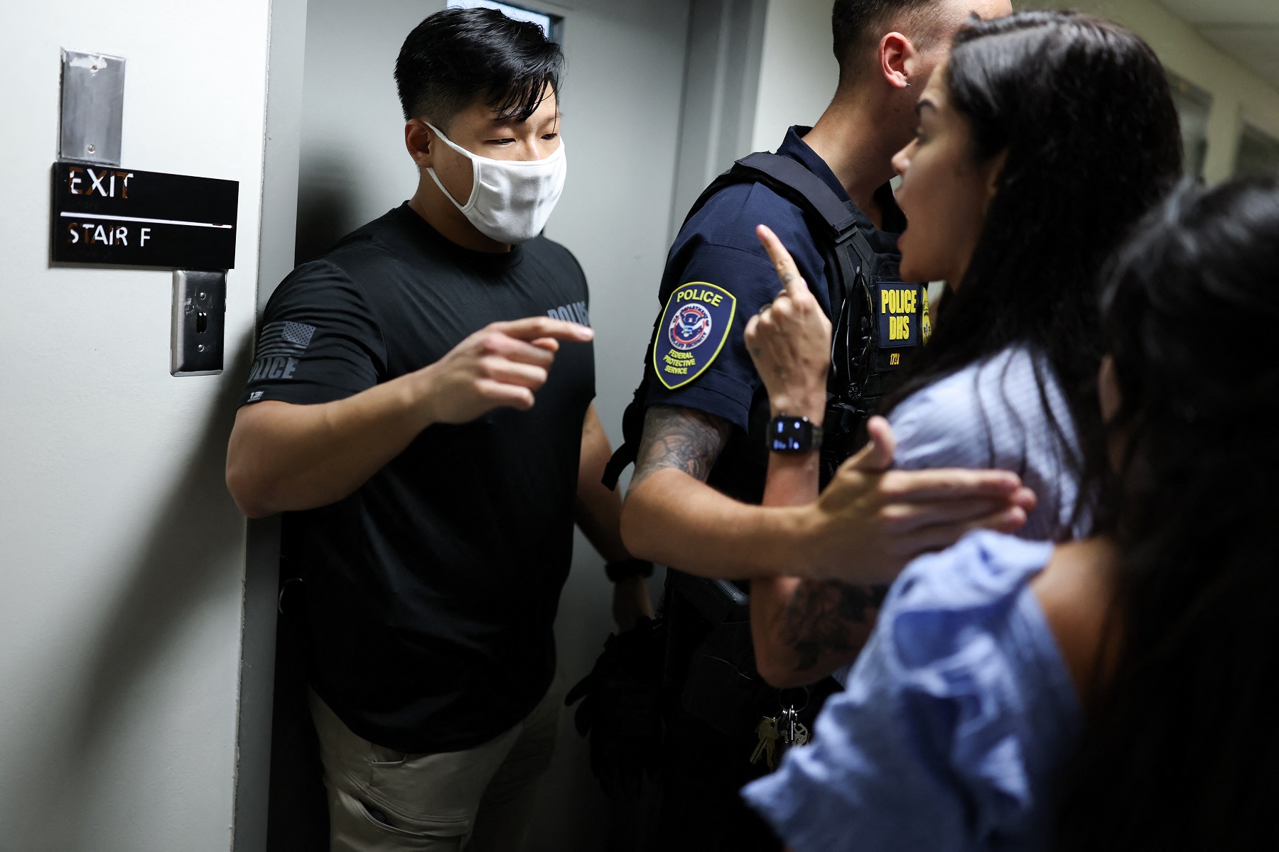 A federal agent (L) warns a legal advisor to back off as the agents detain a main outside of a courtroom after his hearing at New York-Federal Plaza Immigration Court inside the Jacob K. Javitz Federal Building in New York City on July 16, 2025. US President Donald Trump has made deporting undocumented immigrants a key priority for his second term, after successfully campaigning against an alleged "invasion" by criminals. AFP file
