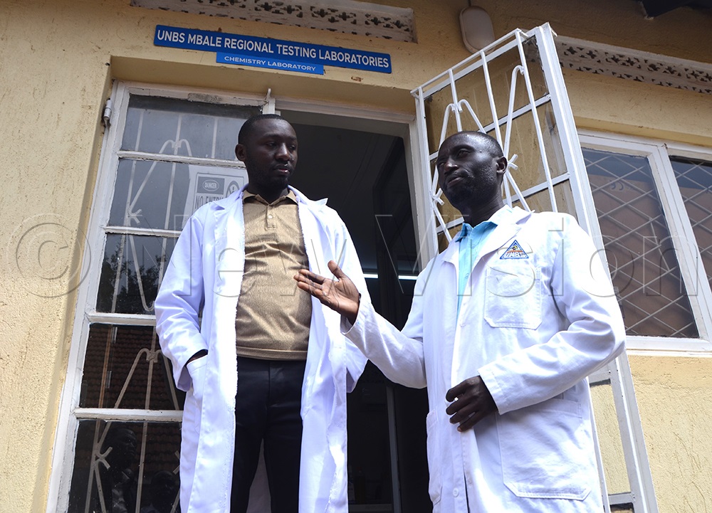 Pius Woniala, a microbiology analyst at the UNBS regional office in Mbale (right) with his fellow worker. (Credit by Delux Emmy Alomu)