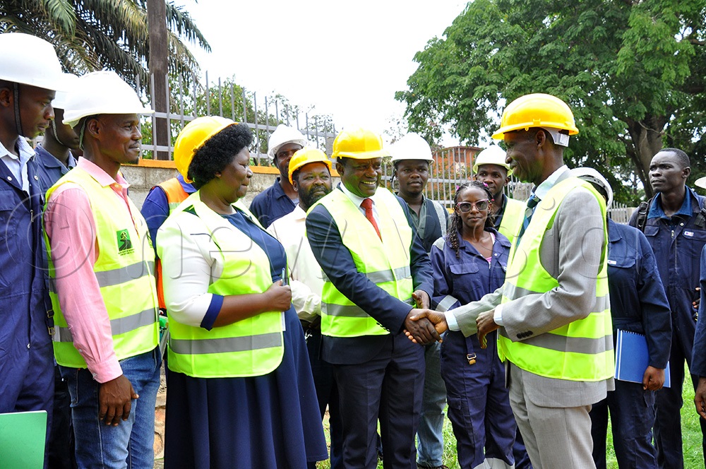  (L-R) Eng Barnabas Mabonga lecturer, Jalia Nasaza Deputy Executive Secretary Uganda Vocational Technical Assessment Board (UVTAB) and engineering students look on as Martin Muyingo the Head teacher of Makerere College School interacts with Anthony Mugagga Muwagga Principal College of Education. (Photo by Nancy Nanyonga)
