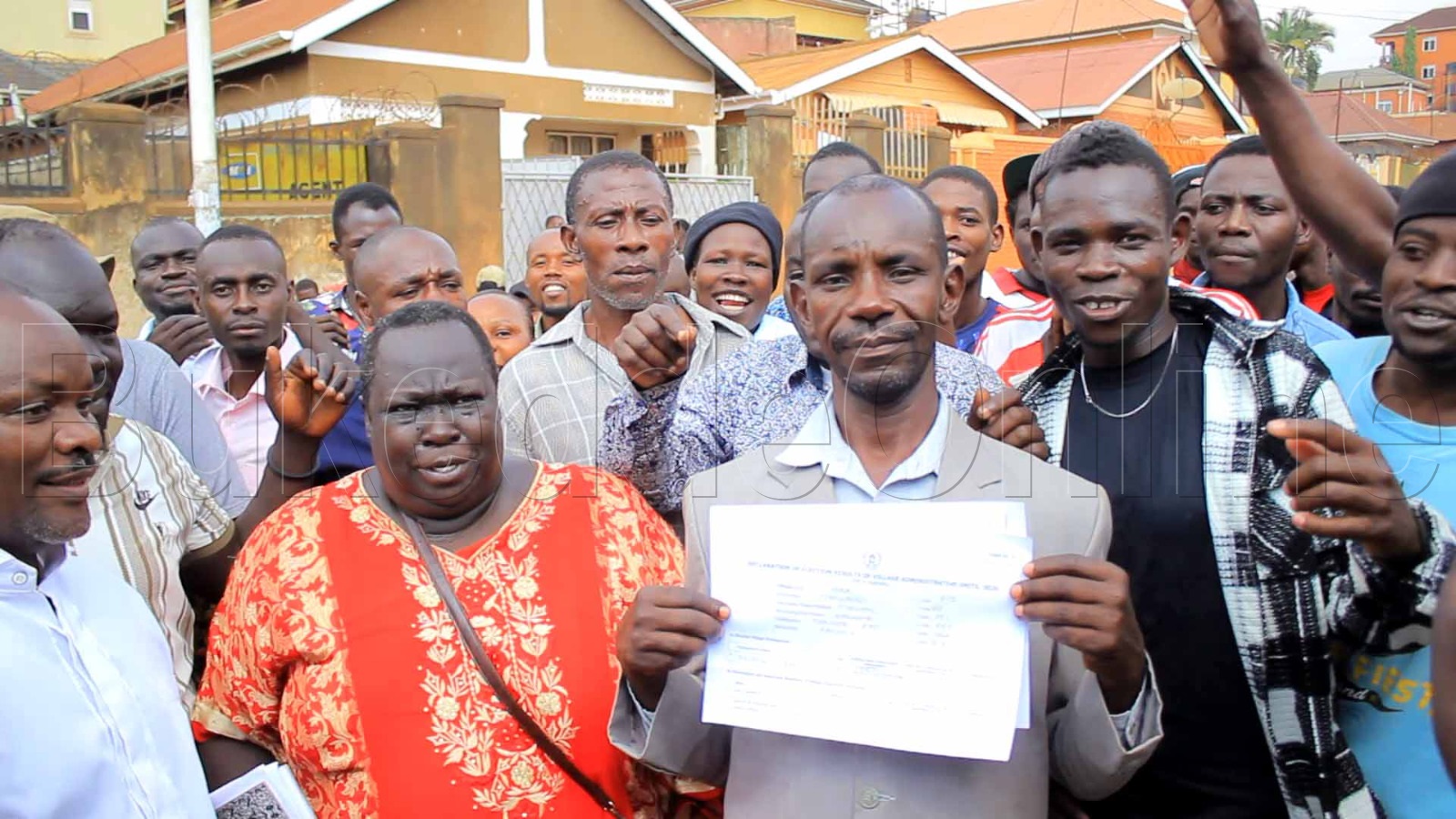 Fred Mwesige akutte empapula ( wakati) n&oacute;lukiiko lwe lwe yalonze oluvanyuma lw&oacute;kuwangula obwa Ssentebe bwa YOKA zooni e Namuwongo