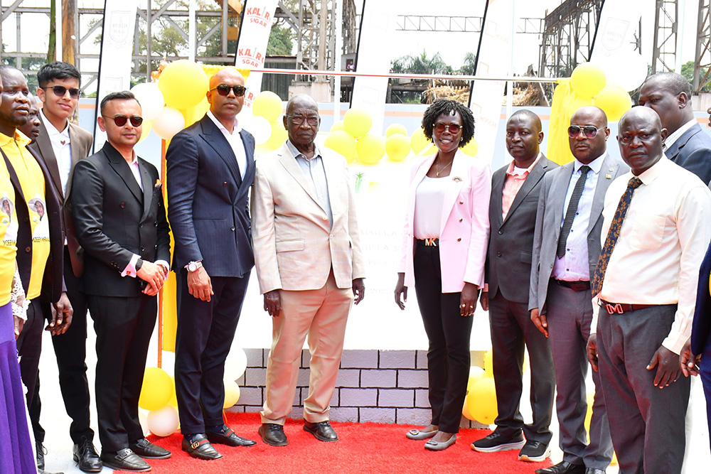 Modern Groups' Rajin Patel (3rd left), Modern Group Chairman Ashish Monpara (4th left), the Minister of Trade, Industry and Cooperatives Francis Mwebesa (middle) the Minister of State for Investment and Privatisation Evelyn Anite (4th right), the Minister of State for Trade David Bahati (3rd right) and Kaliro RDC Thomas Matende (2nd right) in a group photograph after launching the Kaliro Sugar Factory on Friday in Kaliro district. (Photo by Donald Kiirya)