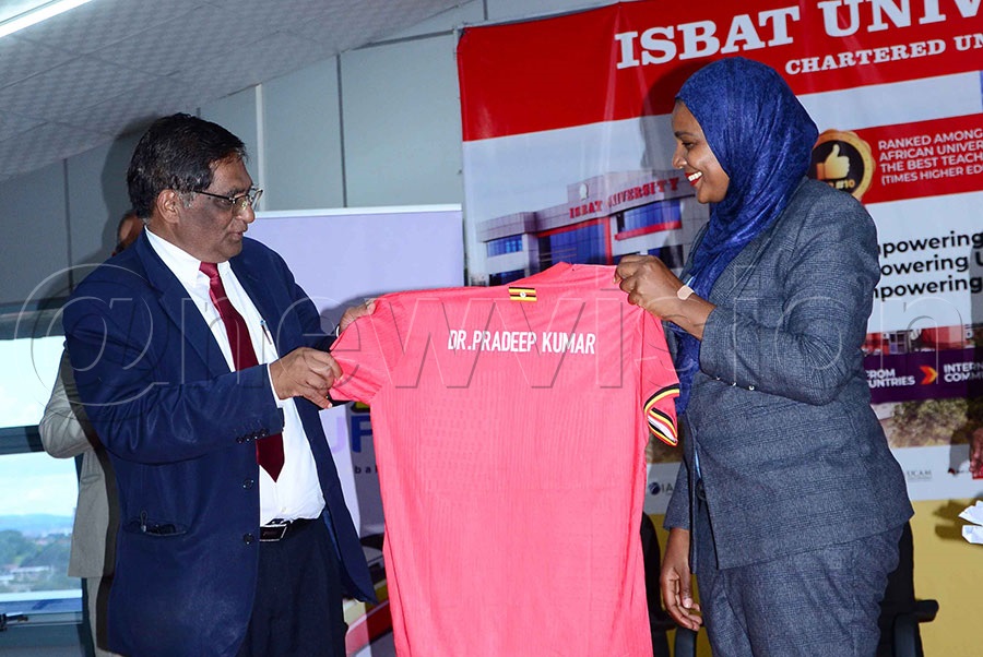  Dr Azar Taibu, FUFA Second Vice President (right) hands over the national team jersey to Prof. Matthew Kalmatacal (left), Vice Chancellor of ISBAT University