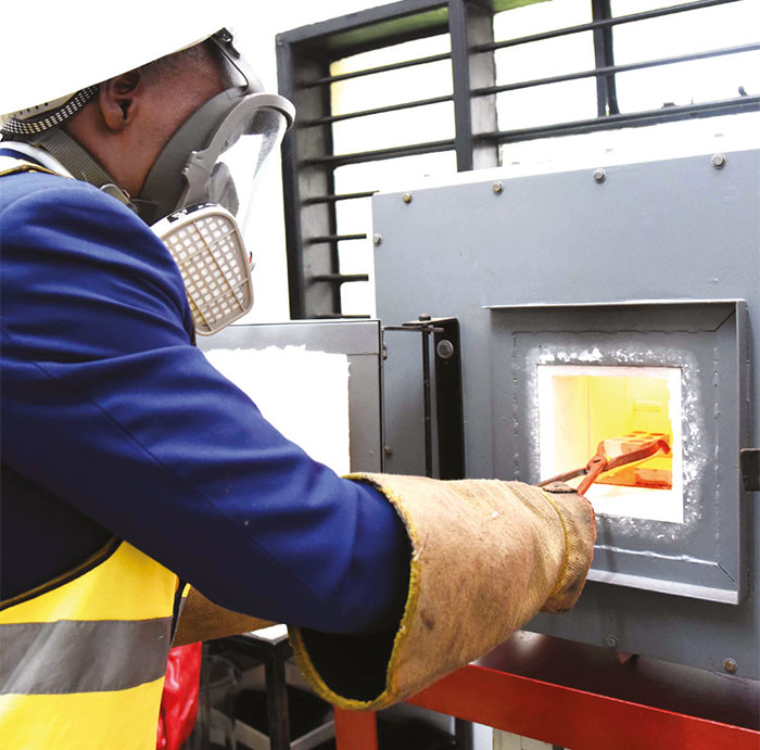 An employee operates a furnace at the facility