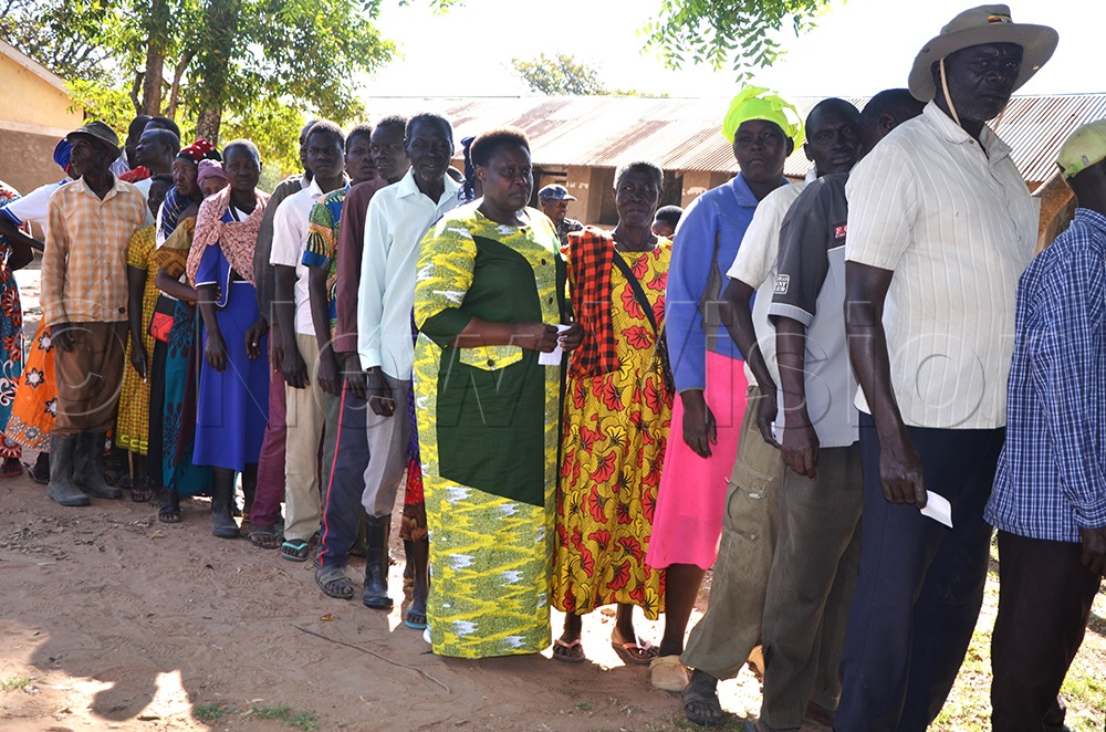 Vice president Jessica Alupo standing in line together with other voters.