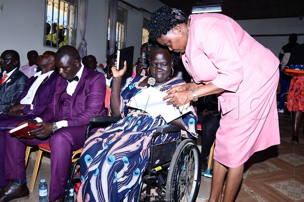 Margallen Tino councilor representing the disabled being sworn in by the CAO Ngora Stella Abyeto. (Photo by Godfrey Ojore)