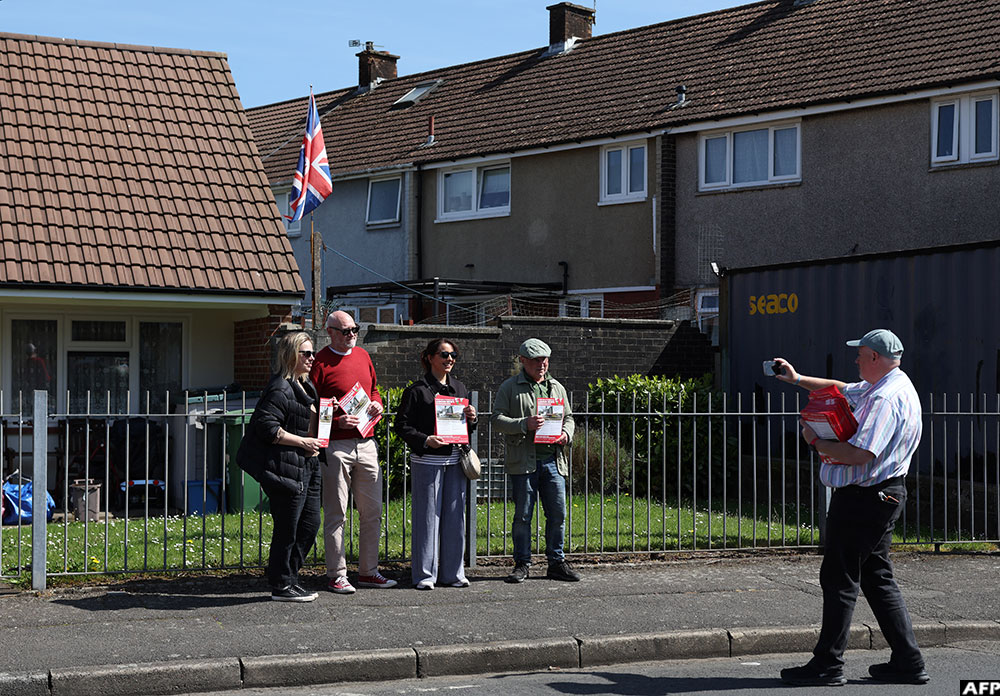 Supporters of Labour Party Senedd election candidate Huw Thomas pose for a photograph after canvassing in the Llanrumney suburb of Cardiff, South Wales on April 23, 2026. (AFP)