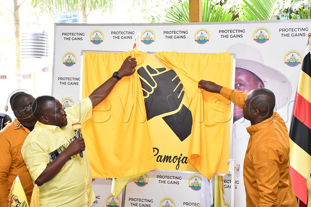 Richard Todwong, the NRM secretary general and David Kabanda, the PLU secretary general unveiling their campaign slogan Tuko Pamoja at the NRM secretariat. (Photo by Simon Peter Tumwine)