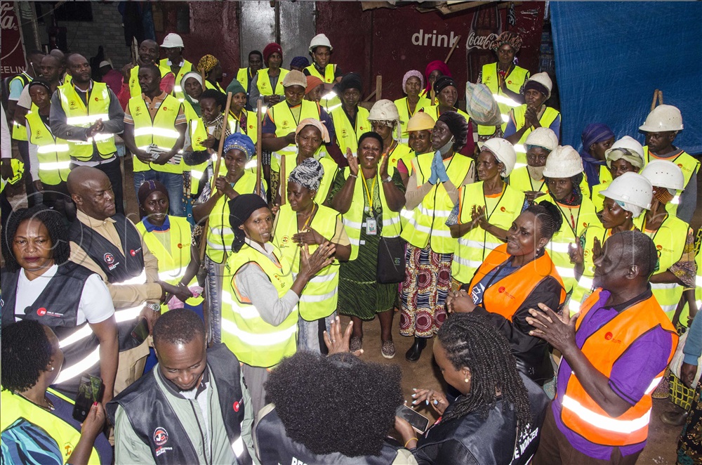 Workers’ Member of Parliament, Abdulhu Byakatonda (Second left second row), Public Services International Officials and Kampala street sweepers interact during the distribution of Personal protective equipment exercise on Thursday, 21 August 2025.