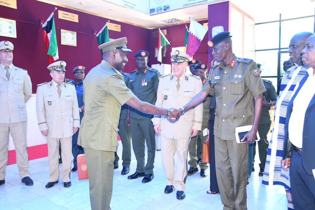 NDC-U commandant, Brigadier General Alex Opolot Olupot, meeting one Ugandan course member on a senior command course. (Courtesy)