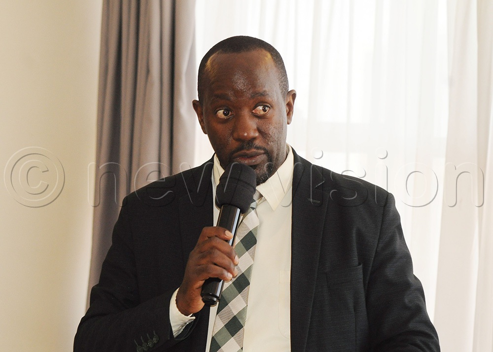 Zacary Katusiime, the senior skills development and technology innovation officer at the Ministry of Gender, Labour and Social Development addressing participants. (Photo by Agnes Kyotalengerire)