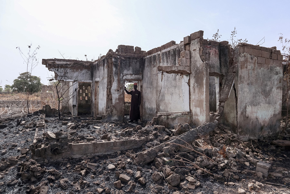 This photograph taken on March 31, 2024 shows Vice Principal Bature Sule surveying the wreckage of a dormitory destroyed by Boko Haram fighters at the Chibok Government Girls Secondary School in 2014. 