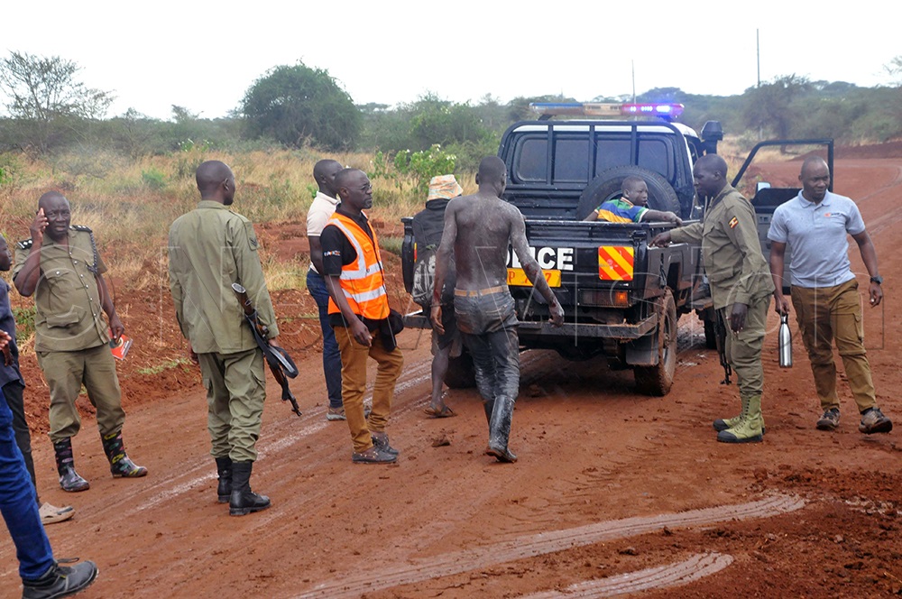 Police officers at the scene where youth were rescued from the truck carrying limestone that had overturned, burying two young loaders. This was along the 'Rupa-Kenya' Highway in Rupa subcounty in Mororto District. They were rescued and rushed to Moroto Hospital. (Photo by John Odyek)