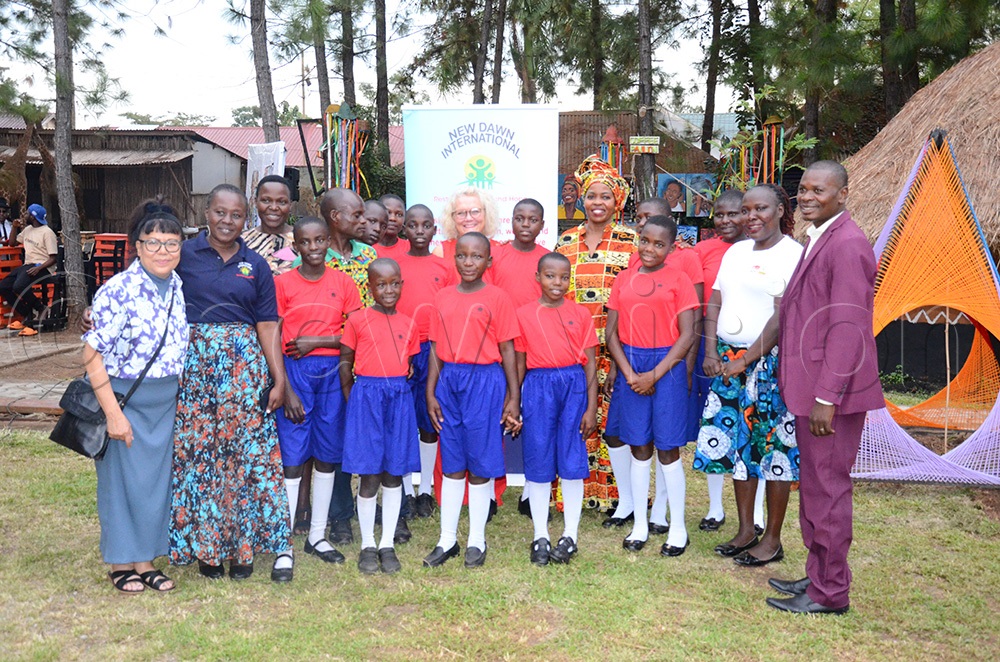 Pupils of New Dawn Primary School with Jo Midgely, the deputy Vice-Chancellor of the University of the West England (left) and Karamoja state minister Barbara Nambozo (In Kitenge). (Photo by Sam Wakhakha)