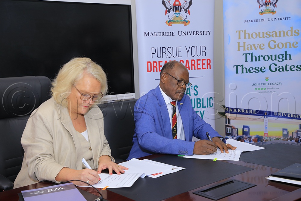 Deputy Vice Chancellor of the University of England Jo Midgley, and Makerere University Vice Chancellor, Prof Barnabas Nawangwe, sign a memorandum of understanding on Friday, October 17, 2025, at Makerere University. (All Photos by Miriam Najjingo)