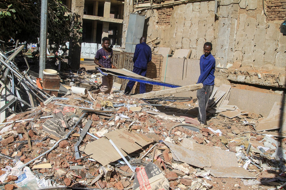 Construction workers remove debris as efforts to restore the city’s infrastructure resume after nearly three years of devastation caused by war, in the capital Khartoum on January 17, 2026. (Photo by Ebrahim HAMID / AFP)