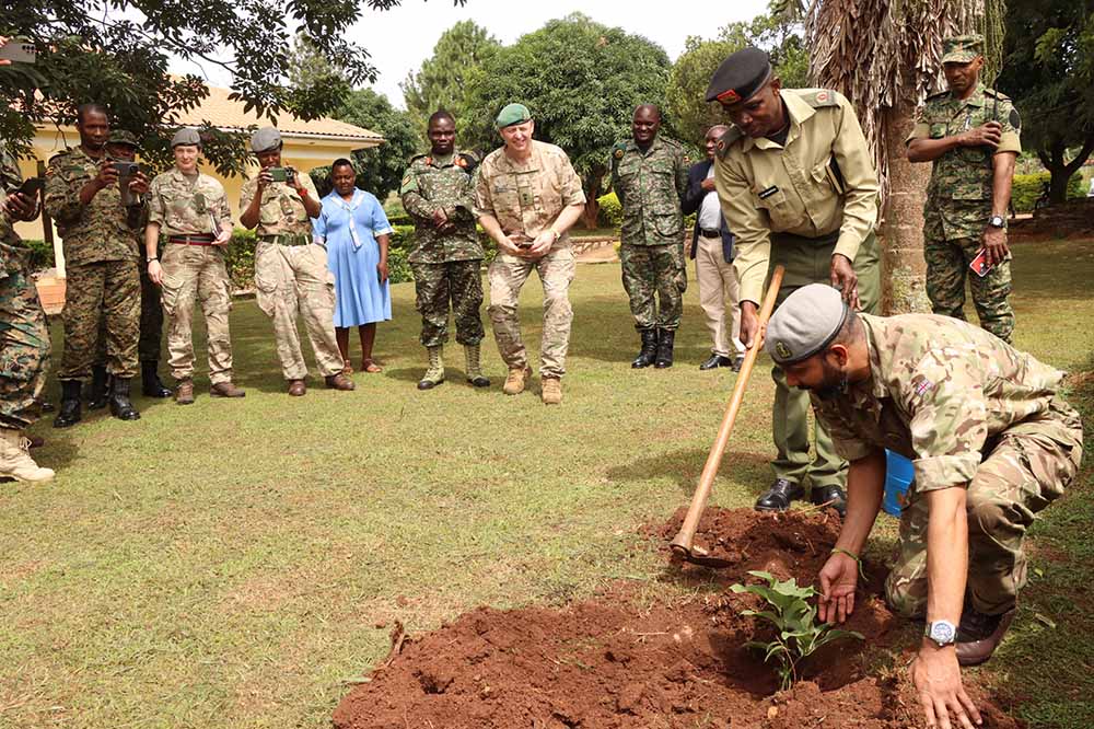 Lt. Col Dr-Jeyanathan, leader of the UK medical military delegation planting a tree during the visit at DFRVC in Mubende. (UPDF Photo)