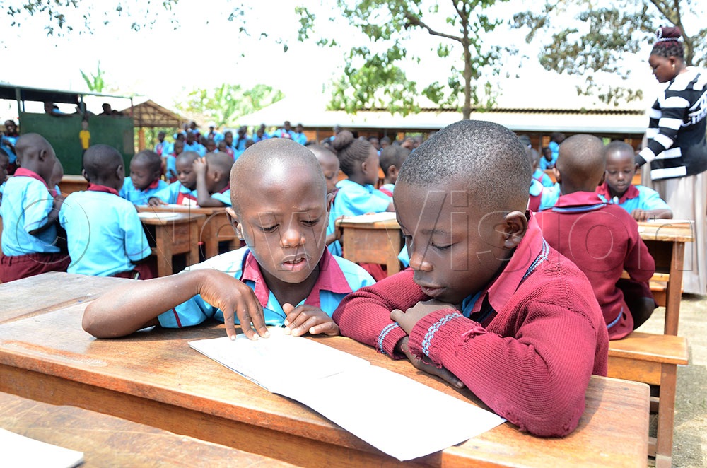 Children reading a story book during the launch of the Writers Program at the school in Lwengo district. (Credit: Lawrence Mulondo)