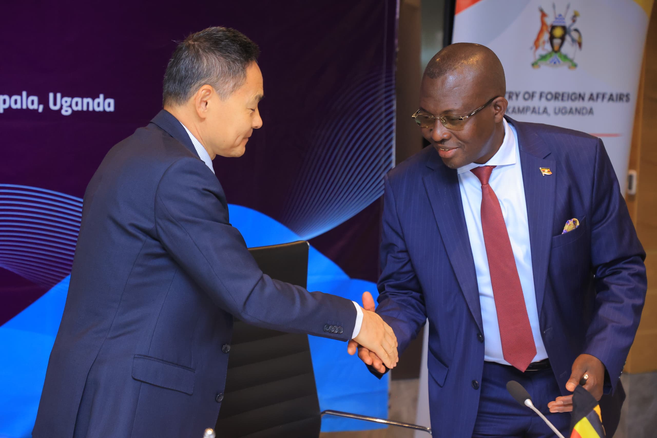 John Mulimba, Minister of State for Foreign Affairs (Regional Affairs) shaking hands with Xue Bing, China’s Special Envoy for the Horn of Africa Affairs, during the opening session on Monday, July 29. (Credit: Ministry of Foreign Affairs)